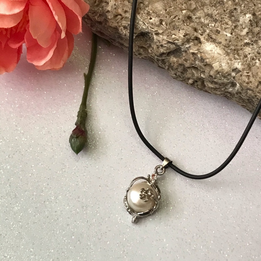 Single real pearl on black leather cord